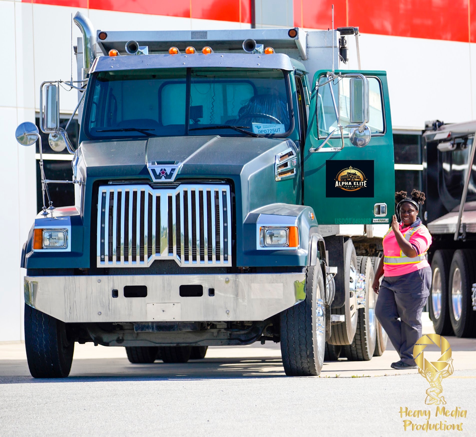 Alpha Elite Trucking dump truck at a gravel construction site