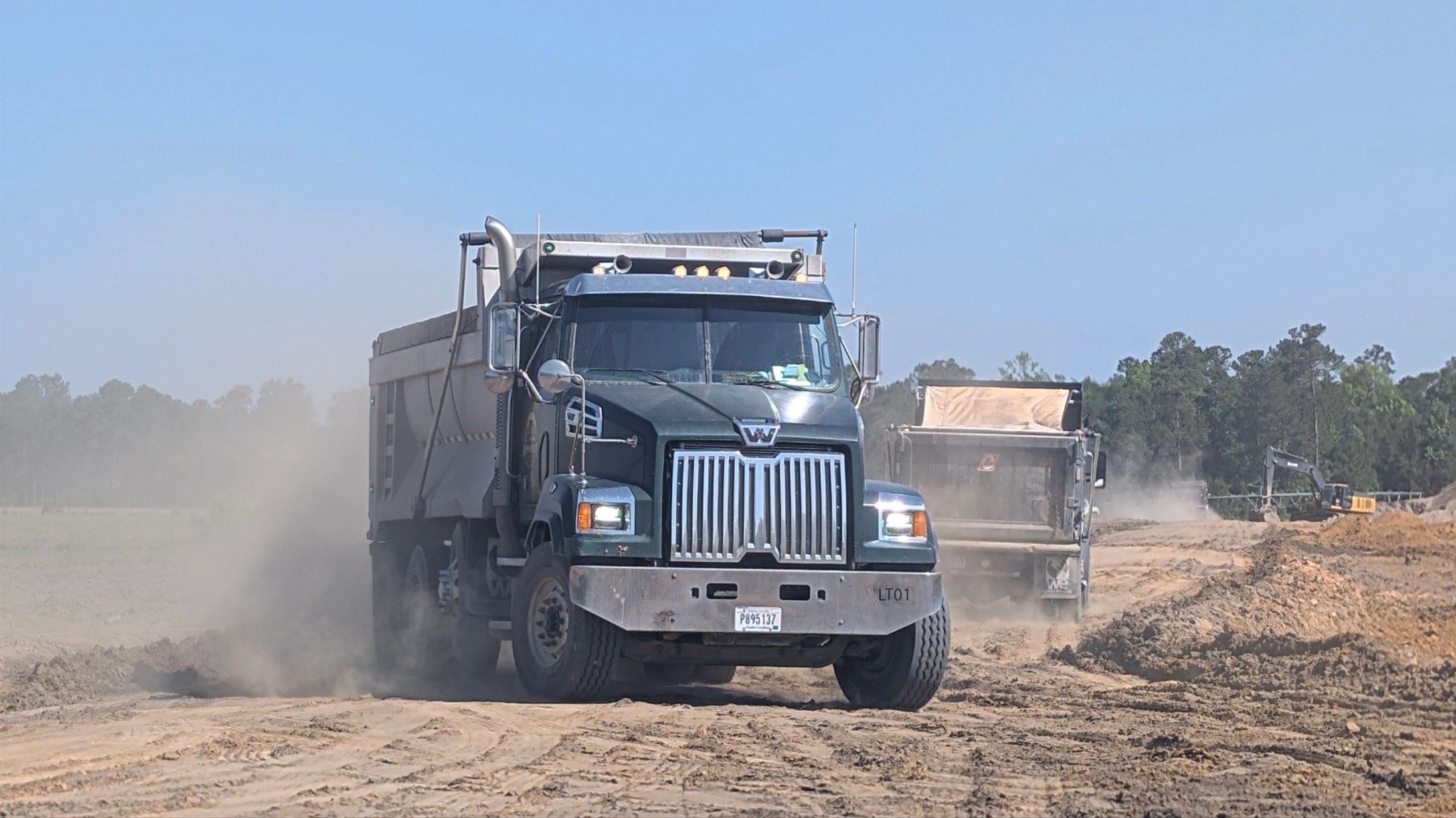 Alpha Elite dump truck on a dusty construction site